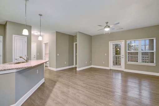 spacious living area with patio door and kitchen island at York Woods at Lake Murray Apartment Homes, Columbia, SC