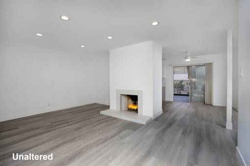 A modern living room with a fireplace and wood flooring.
