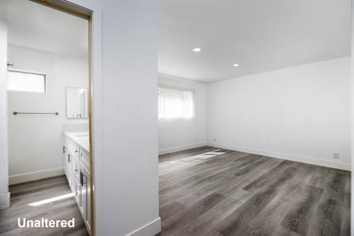 A room with a wooden floor and white walls.