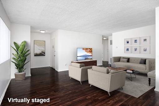 A living room with a couch, chair, and television.
