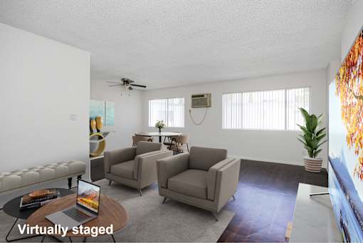 A living room with a couch, chairs, and a coffee table.
