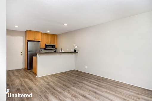 A kitchen with wooden cabinets and a white countertop.