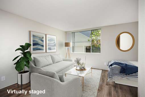 A living room with a couch, a table, and a lamp.