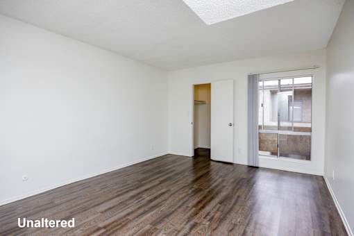 A room with wooden floors and white walls.