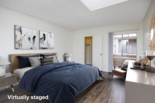 A bedroom with a bed, nightstand, and a painting on the wall.