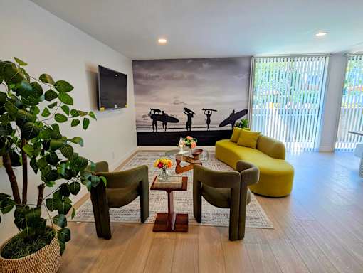 A living room with a surfboard mural on the wall.