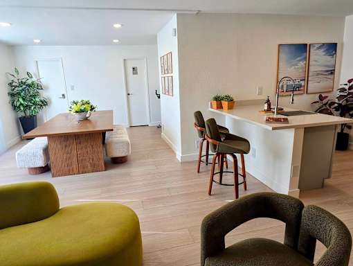 A living room with a green couch and a wooden table.