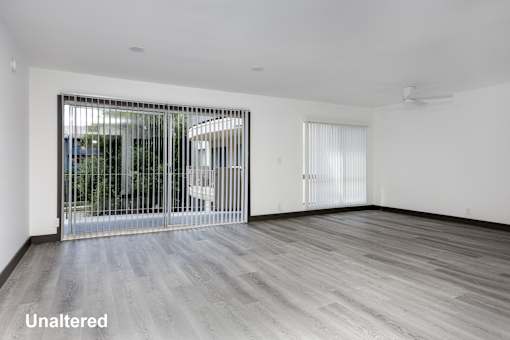 A room with a sliding door and unaltered flooring.