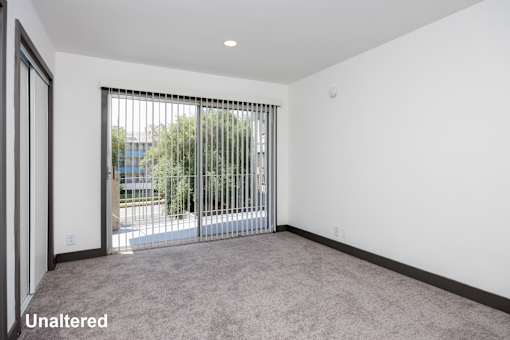 A room with a sliding door leading outside.