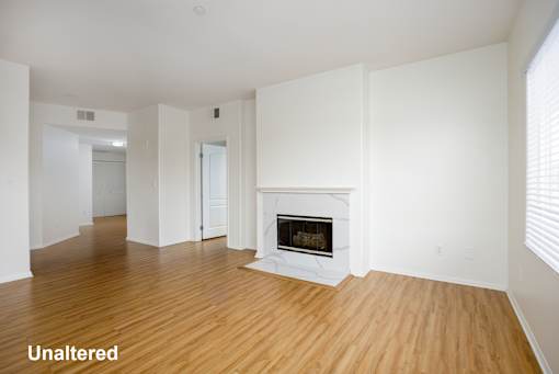 A room with a fireplace and wooden floors.