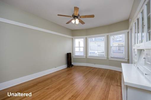 A room with a ceiling fan and hardwood floors.