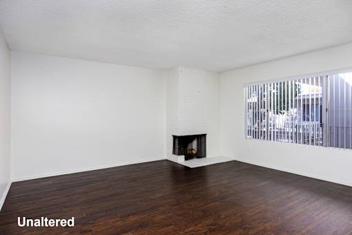 A room with a fireplace and wooden floors.