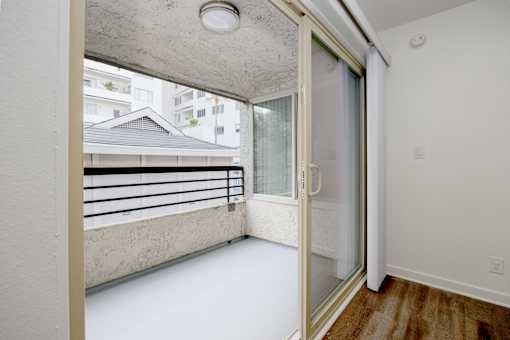 a bedroom with a balcony and a door to a balcony