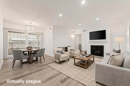A living room with a fireplace and a television.