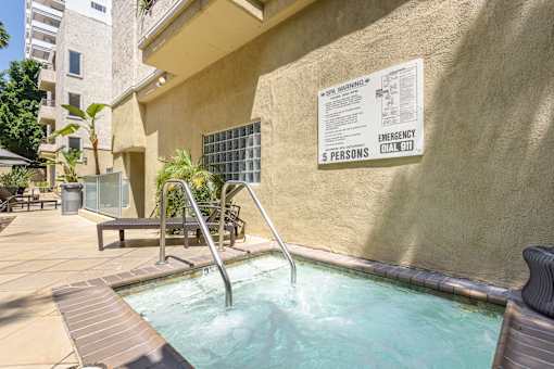 A pool with a warning sign on the wall.