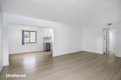 A room with wooden floors and white walls.