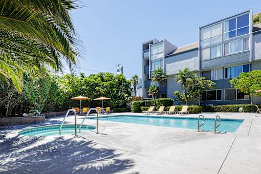 a swimming pool with a building in the background