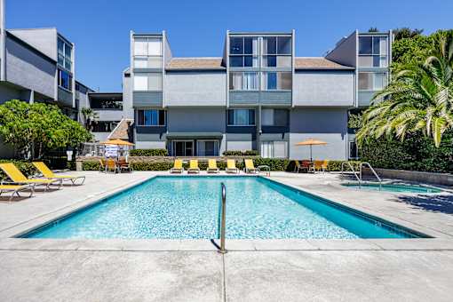 a swimming pool in front of an apartment building