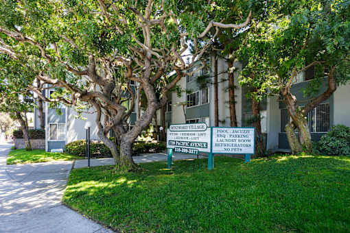 a sign in front of a building with trees