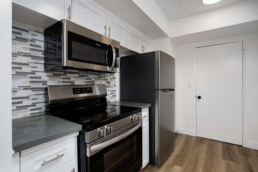 a kitchen with stainless steel appliances and a refrigerator