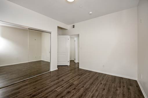 A room with a wooden floor and white walls.