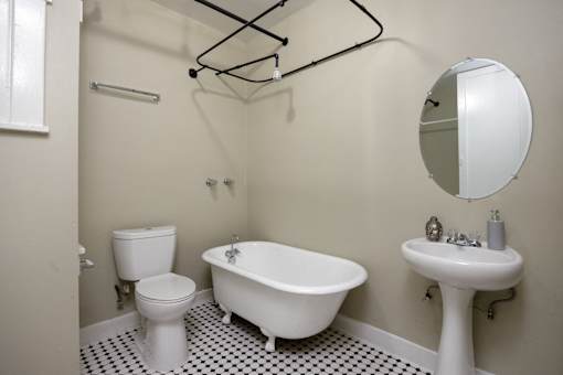 a white bathroom with a sink toilet and bath tub