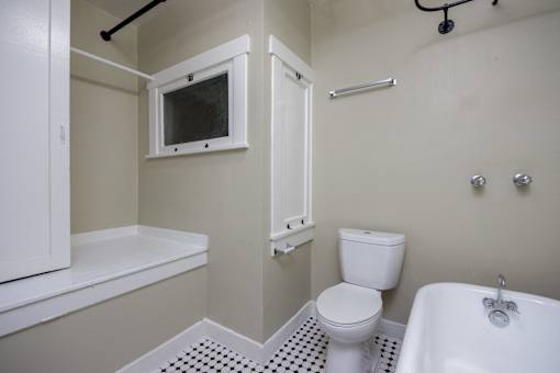 a bathroom with a toilet and a bath tub and a sink
