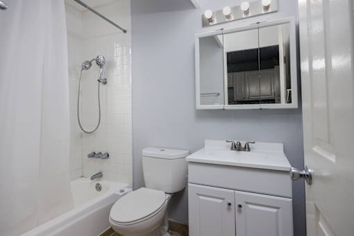 A white toilet and sink in a bathroom.