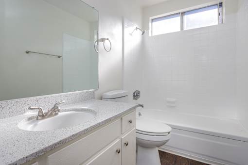 an empty bathroom with a sink toilet and shower