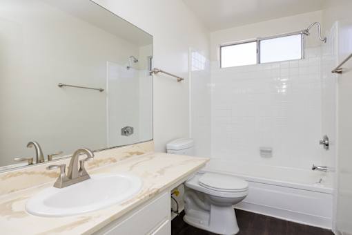 a bathroom with a sink toilet and a shower