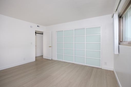 an empty room with a large white wall and a door