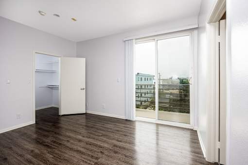 a living room with a large window and a door to a closet
