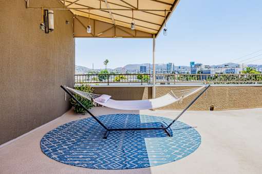 a hammock on a balcony with a view of the city