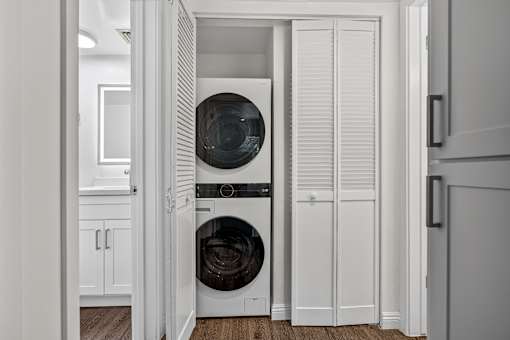 A white laundry room with a washer and dryer.