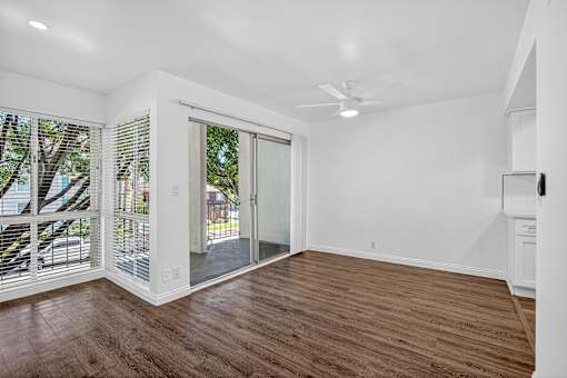 A room with a sliding glass door leading to a balcony.