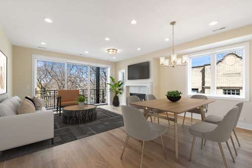 A modern dining room with a wooden table and chairs.
