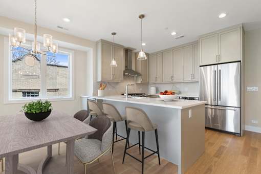 A modern kitchen with a dining table and chairs.