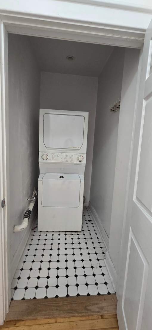 A white microwave oven is installed in a kitchen cabinet.
