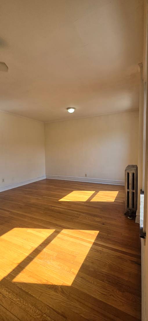A wall with a window and a vent on top.