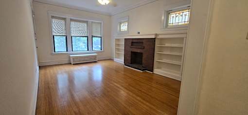 A room with a fireplace and a window.
