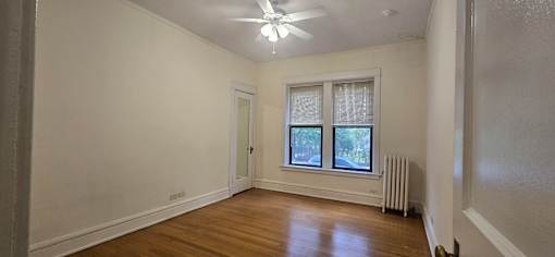 A room with a window and a fan.