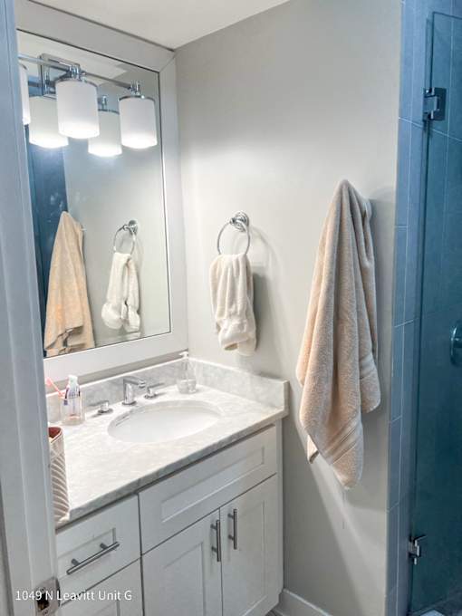a small bathroom with white cabinets and a white sink