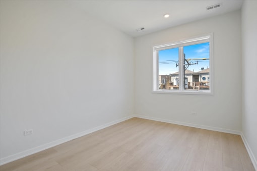 a living room with white walls and a window