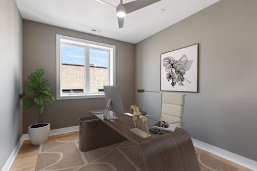 A room with a brown desk and a white chair.