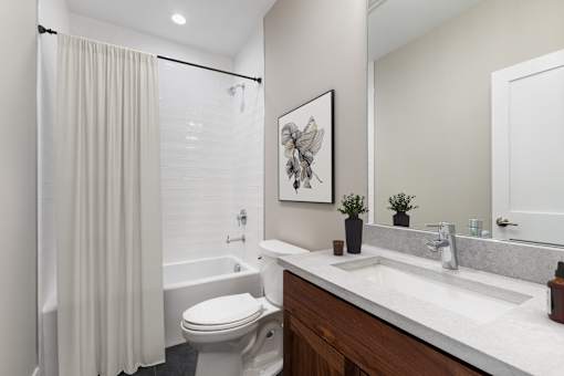 A white toilet sits next to a sink in a bathroom.