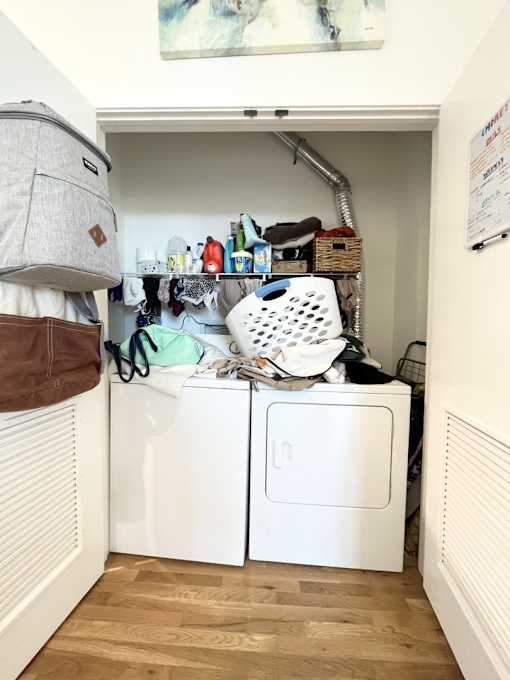 A small laundry room with a washer and dryer.