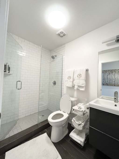 A white toilet in a bathroom with a glass shower door.