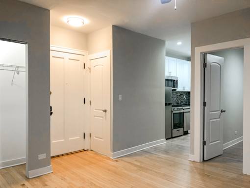 A kitchen area with a refrigerator, oven, and sink.