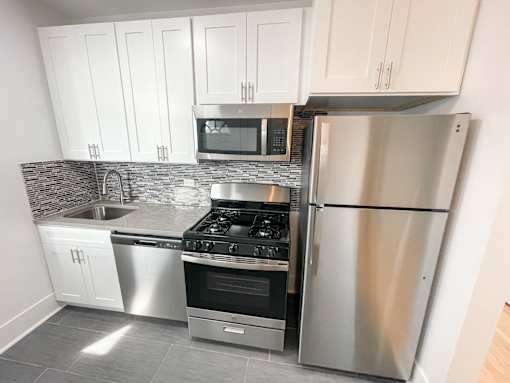 A kitchen with a stove, oven, and refrigerator.