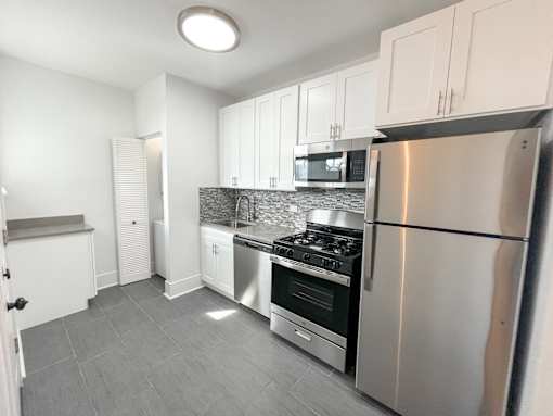 A kitchen with a stove, oven, and refrigerator.